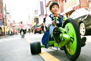 korean boy rides through suwon ecomobility festiva